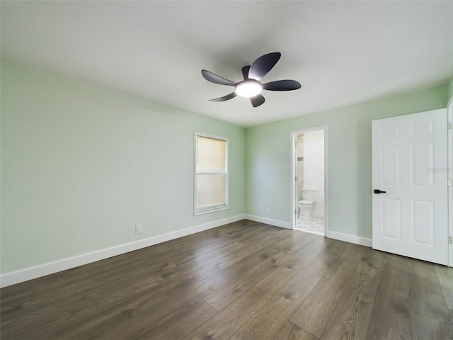 unfurnished bedroom with ceiling fan, connected bathroom, and dark hardwood / wood-style floors