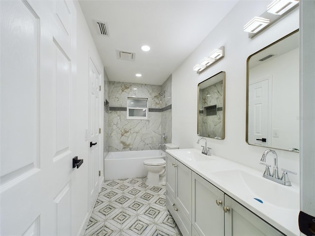 full bathroom featuring vanity, toilet, and tiled shower / bath