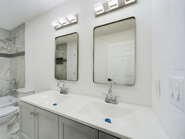 full bathroom with tiled shower / bath combo, vanity, and toilet