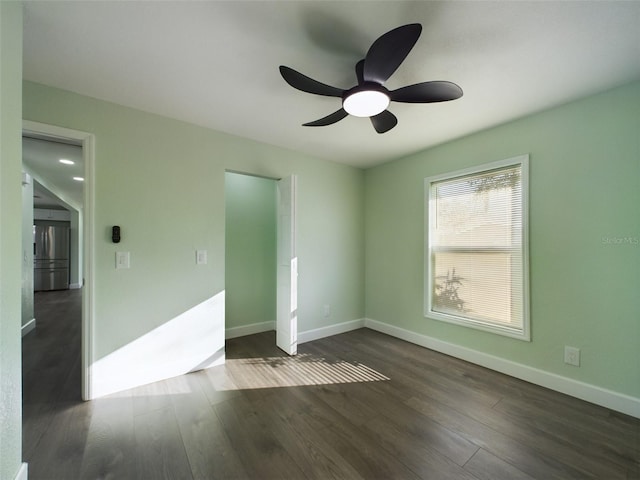 unfurnished bedroom featuring ceiling fan and dark hardwood / wood-style flooring