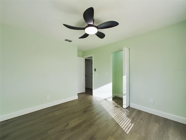 unfurnished bedroom featuring ceiling fan and dark hardwood / wood-style flooring