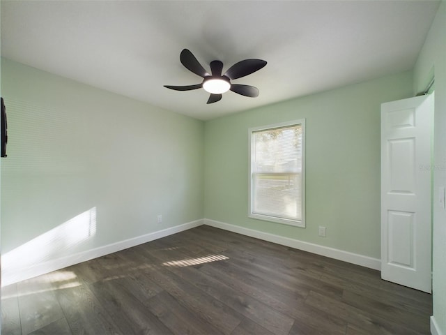 unfurnished room featuring ceiling fan and dark hardwood / wood-style floors