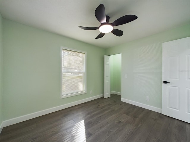 unfurnished bedroom with dark wood-type flooring and ceiling fan