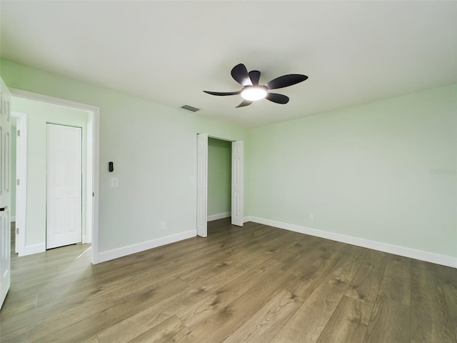 spare room with light hardwood / wood-style floors and ceiling fan