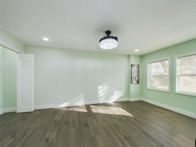 empty room with dark hardwood / wood-style flooring