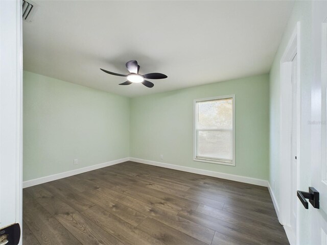 spare room featuring dark hardwood / wood-style floors and ceiling fan