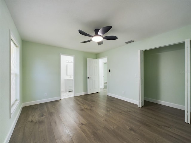 unfurnished bedroom with ceiling fan, connected bathroom, and dark hardwood / wood-style floors