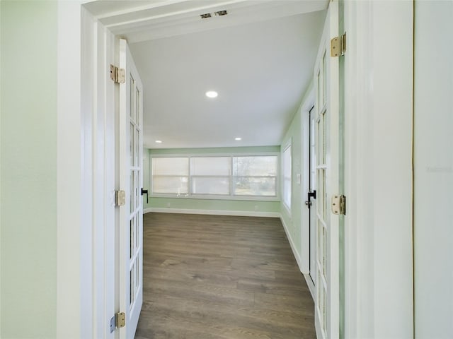 hallway with dark hardwood / wood-style flooring