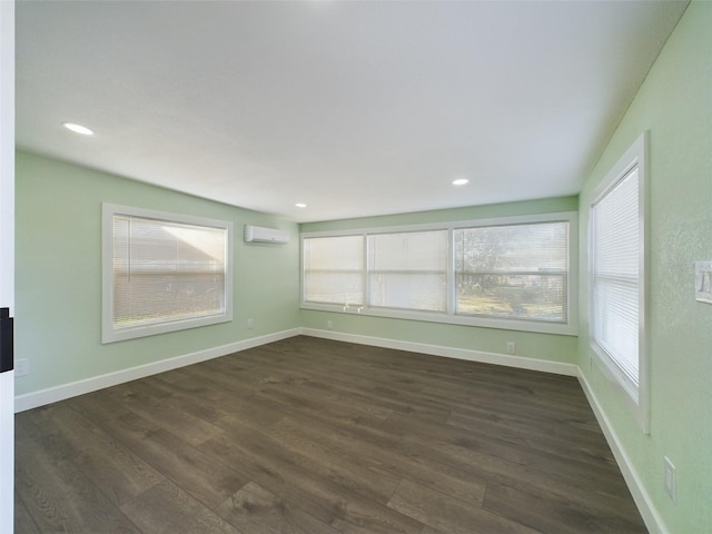 unfurnished sunroom featuring a healthy amount of sunlight and a wall mounted AC