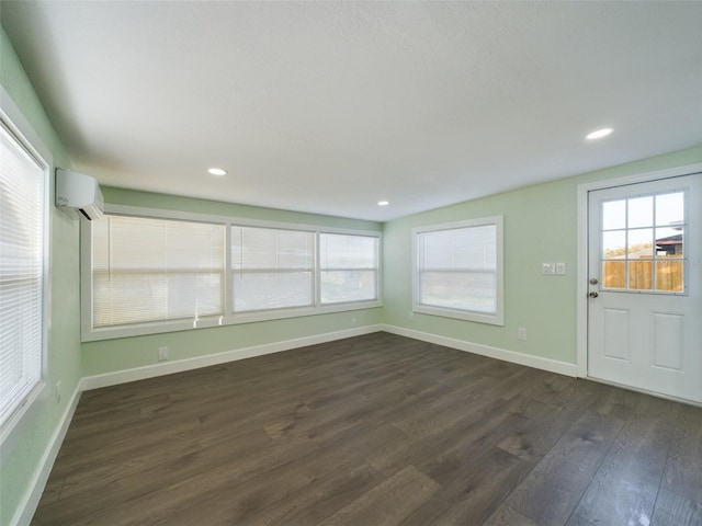 unfurnished sunroom with plenty of natural light and a wall mounted AC