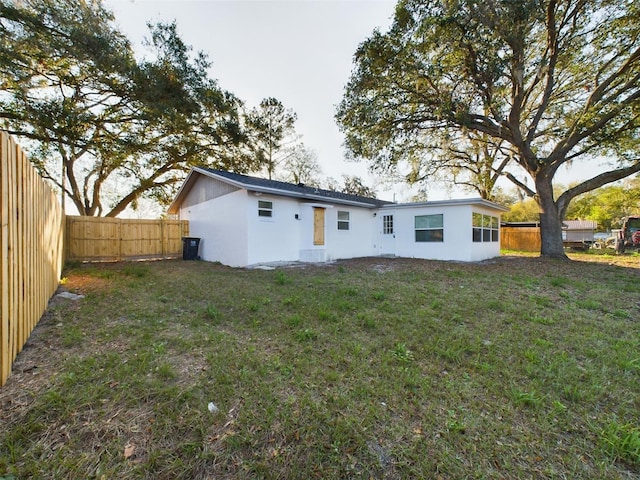 back of house featuring a yard