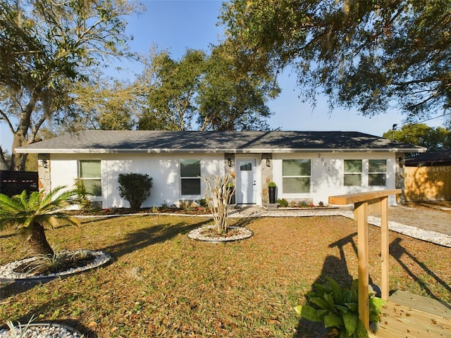 ranch-style home with a front lawn