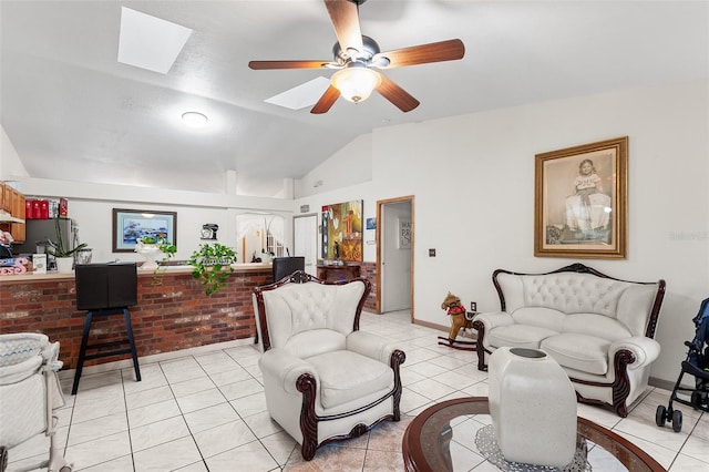 tiled living room with ceiling fan, brick wall, and vaulted ceiling