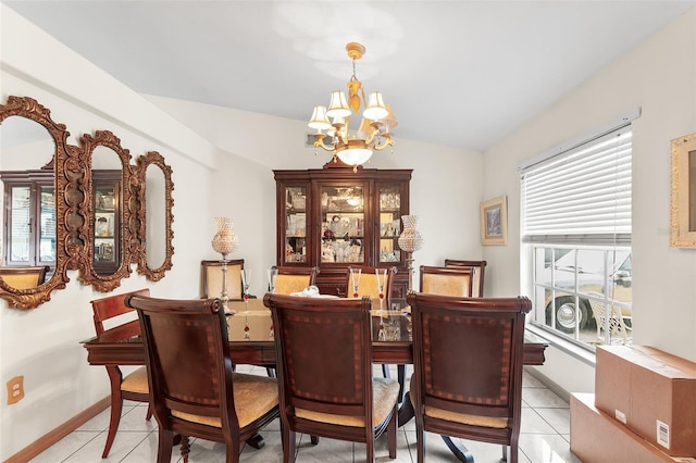 dining space with a notable chandelier, light tile patterned flooring, and lofted ceiling