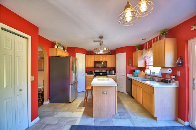 kitchen with black appliances, a center island, sink, and pendant lighting