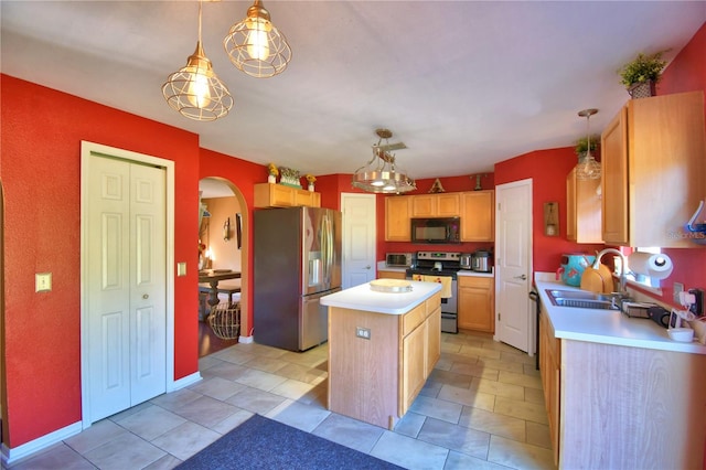 kitchen with sink, a kitchen island, hanging light fixtures, and appliances with stainless steel finishes