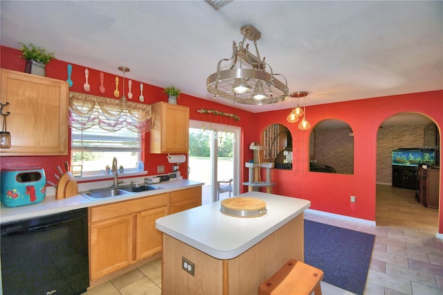 kitchen featuring sink, a kitchen island, pendant lighting, and black dishwasher