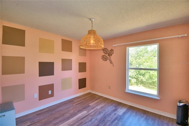 spare room with wood-type flooring and a textured ceiling