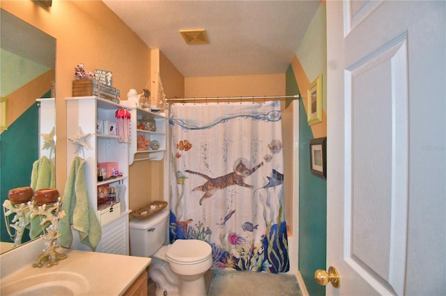 bathroom with vanity, toilet, and curtained shower