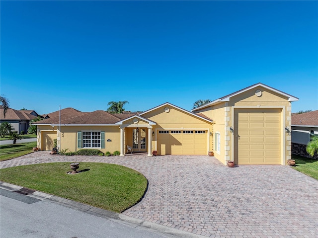 single story home with a front yard and a garage