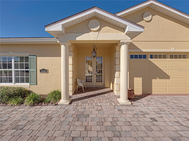 view of exterior entry with a garage