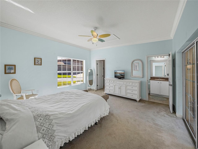 carpeted bedroom featuring ceiling fan, crown molding, and ensuite bath