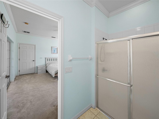 bathroom with ornamental molding and a shower with door