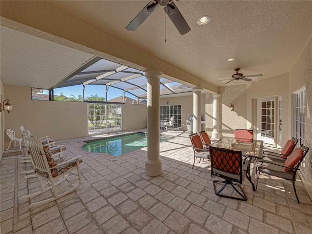 view of swimming pool with a lanai, a patio area, and ceiling fan