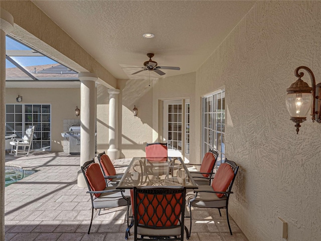 view of patio / terrace with ceiling fan and a swimming pool