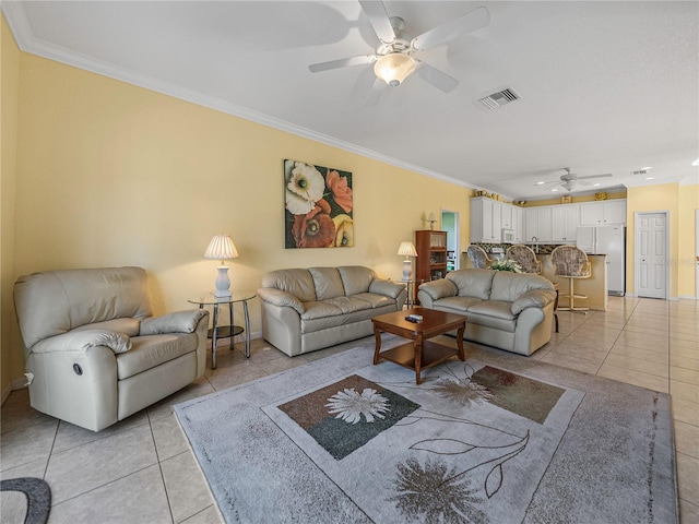 living room with ceiling fan, light tile patterned floors, and ornamental molding