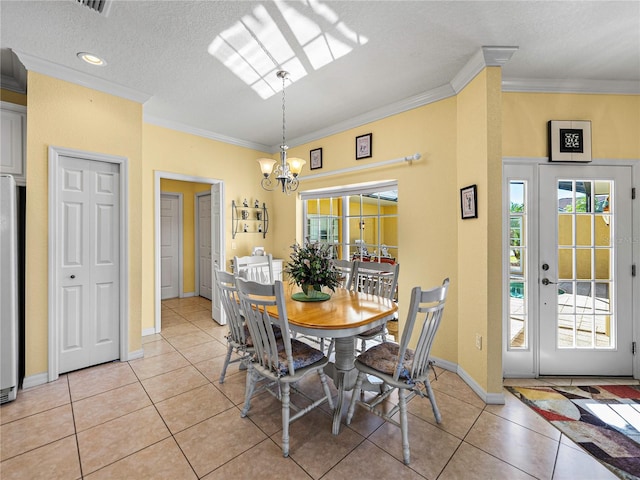 dining space with crown molding, light tile patterned flooring, a textured ceiling, and an inviting chandelier