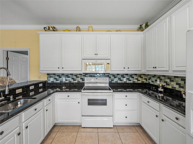 kitchen featuring white cabinets, dark stone counters, white appliances, and ornamental molding