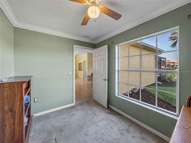 carpeted bedroom featuring ceiling fan, ornamental molding, and a textured ceiling