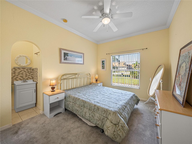 bedroom with ceiling fan, sink, light colored carpet, and ornamental molding