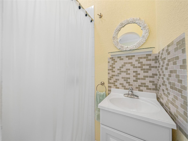 bathroom featuring decorative backsplash and vanity