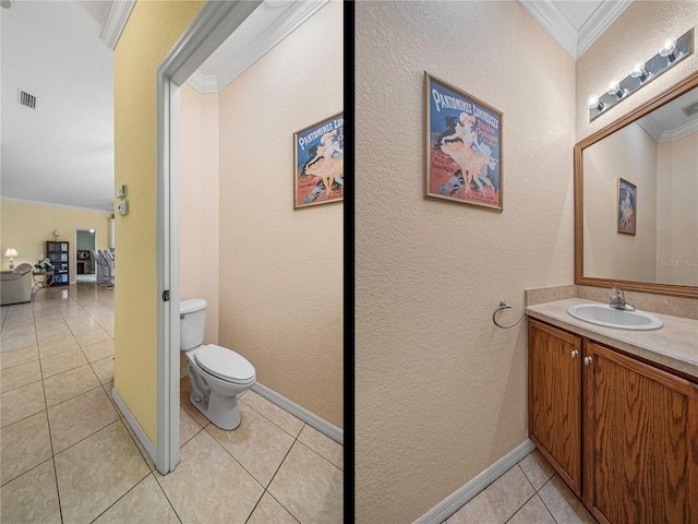 bathroom with toilet, vanity, tile patterned floors, and crown molding