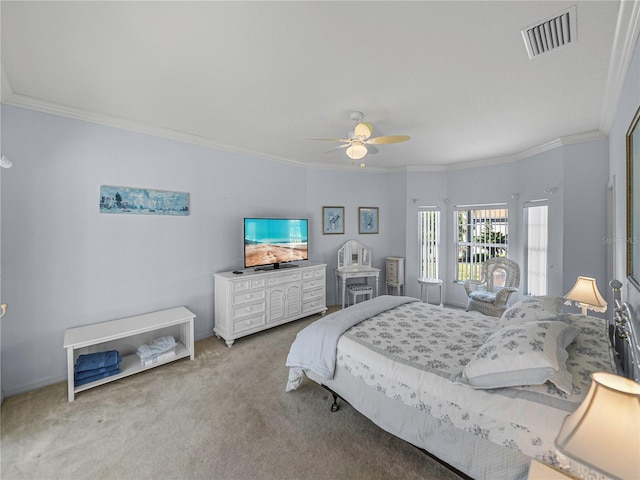 carpeted bedroom featuring ceiling fan and ornamental molding