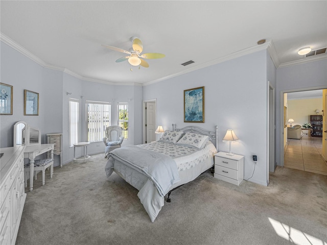 carpeted bedroom with ceiling fan and ornamental molding