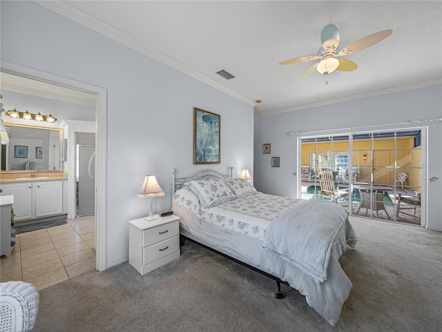 carpeted bedroom with ceiling fan, sink, crown molding, and ensuite bath