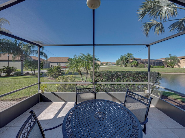 sunroom / solarium featuring a water view