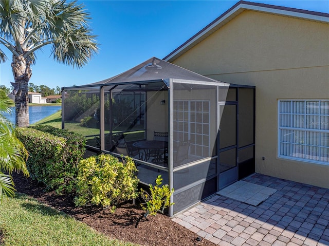 view of side of property with a lanai and a patio area