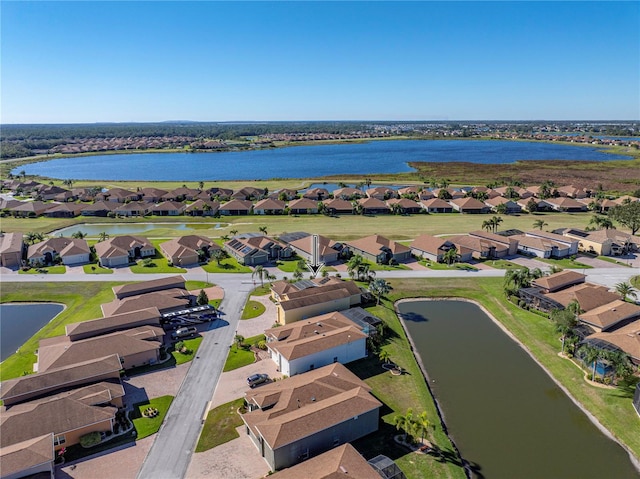 birds eye view of property with a water view