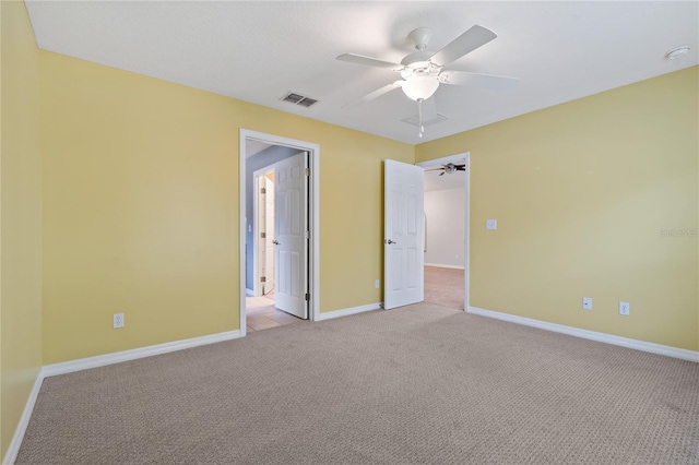 unfurnished bedroom featuring light colored carpet and ceiling fan