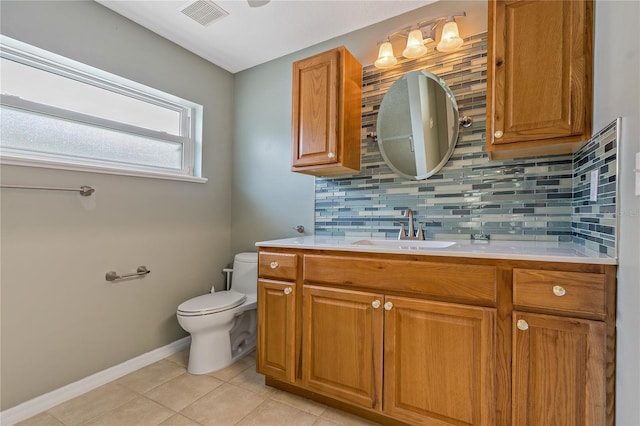 bathroom with backsplash, tile patterned flooring, vanity, and toilet