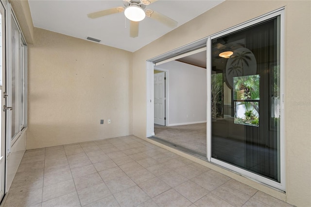 spare room featuring light carpet and ceiling fan