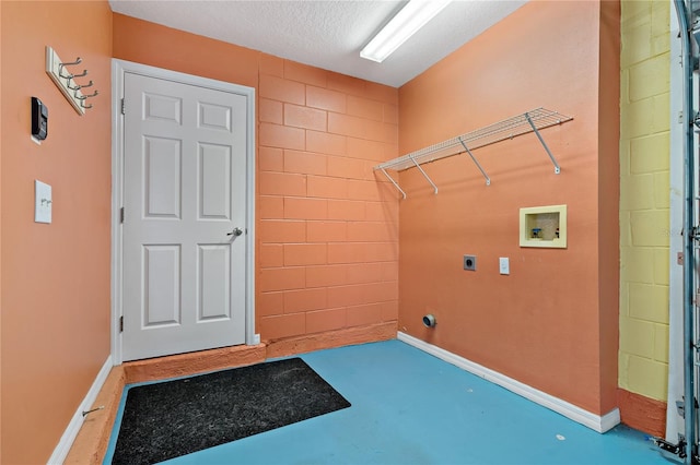 laundry room featuring electric dryer hookup, a textured ceiling, and hookup for a washing machine