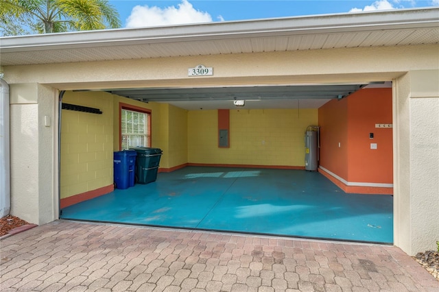 garage with electric panel, a garage door opener, a carport, and water heater