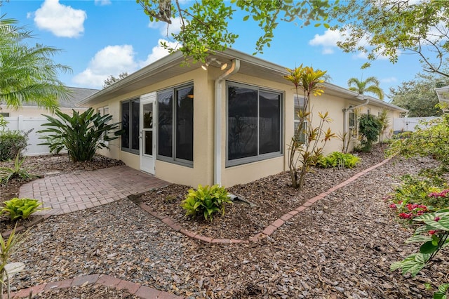 view of side of property with a patio