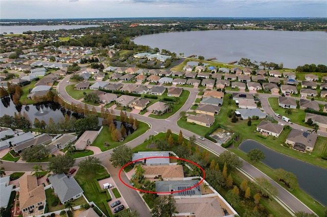 birds eye view of property with a water view