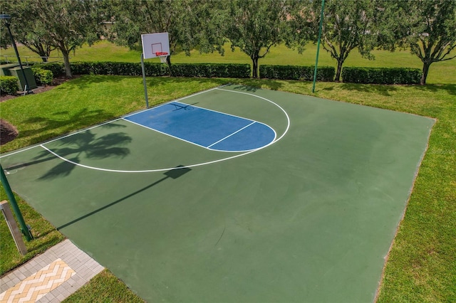 view of basketball court featuring a yard